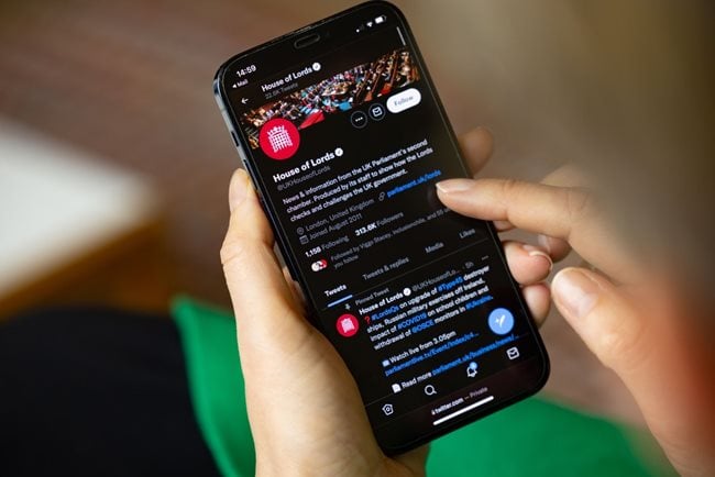 Person looking at House of Lords Twitter on a phone