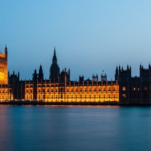 Houses of Parliament at night, lit up with the ruiver Thames in the foreground