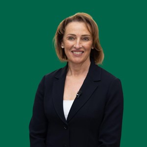 Sarah Pochin, MP for Runcorn and Helsby, against a green background
