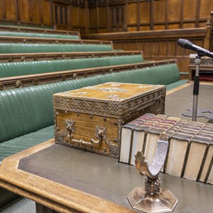 A Despatch box in the House of Commons Chamber, a wooden box bound with ornate brass decoration.