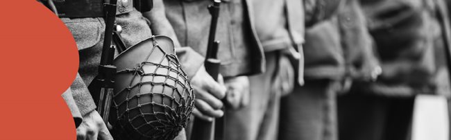 Close up of World War Two soldiers holding a helmet